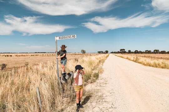 Kids exploring dirt road during times of drought in rural Australia