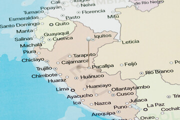 Macro photo of a white pin needle into Pucallpa city of Peru political map 