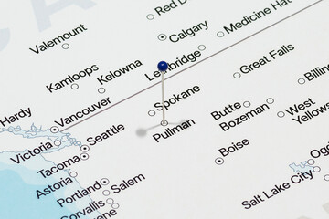 Macro photo of blue pin needle into Pullman city of United States of America political map 