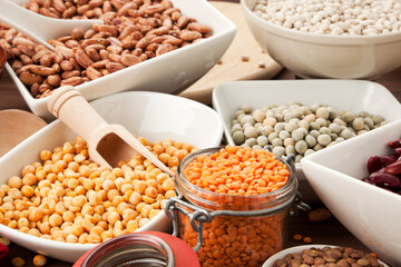 variety of legumes in bowls and glasses