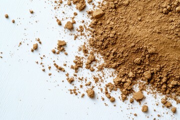 Fine brown powder scattered artistically on clean white surface,