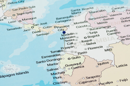 Macro photo of a blue pin needle into Tumaco city of Colombia political map 