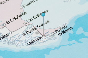 Obraz premium Macro photo of a light blue pin needle into Ushuaia city of Argentina political map 