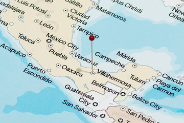 Macro photo of a red pin needle into Villahermosa city of Mexico political map 