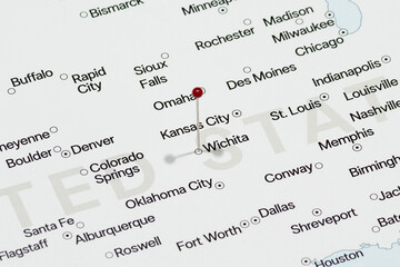Macro photo of a red pin needle into Wichita city of United States of America political map 