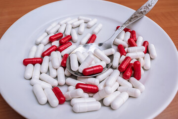 A huge number of diet pills in a plate, overdose of pills