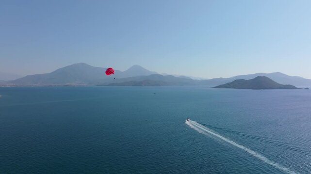 Aerial view of parasailing over the beautiful Mediterranean Sea with islands and mountains, Fethiye, Turkey.