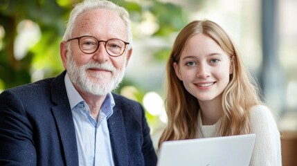 Smiling Elderly Man and Young Woman Working Together Indoors