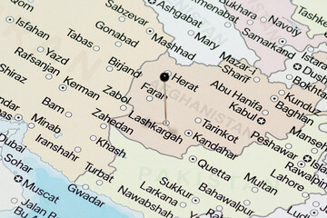 Fototapeta premium Macro photo of a black pin needle into Lashkargah city of Afghanistan political map 