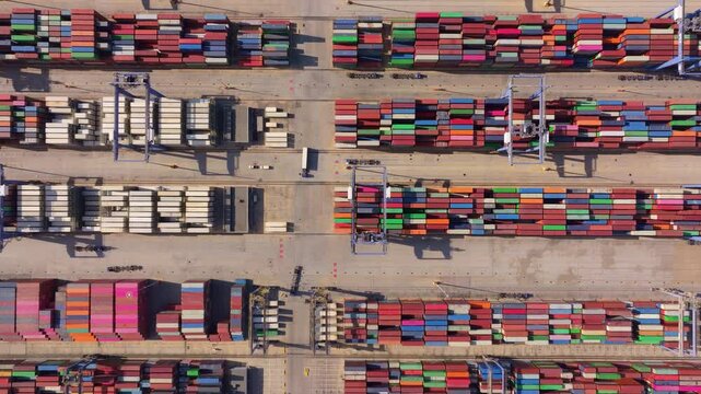Aerial view of a busy container port with stacked containers and cranes, Perama, Greece.