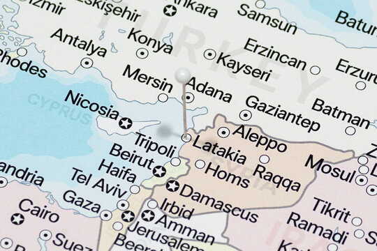Macro photo of a white pin needle into Latakia city of Syria political map 