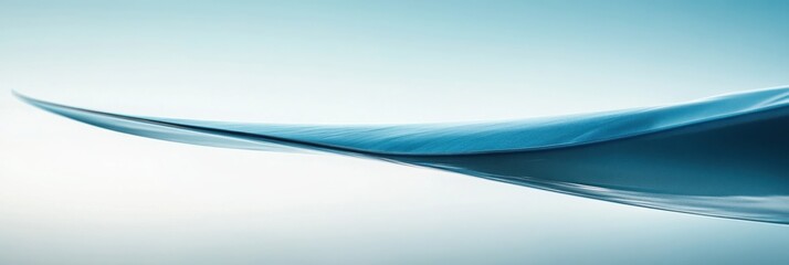 A tranquil, abstract image of a gentle wave, showcasing a smooth gradient of blue hues against a light background.