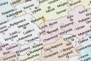 Macro photo of a yellow pin needle into Lviv city of Ukraine political map 