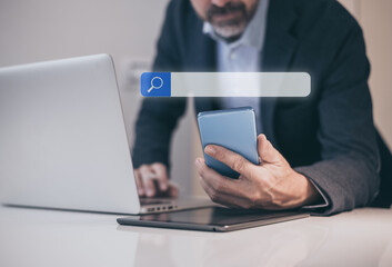 Man use computer and smartphone for searching online. Search engine bar. Browsing Internet concept.
