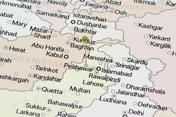 Close up to a Peshawar city with a green pin needle into Pakistan country political map 