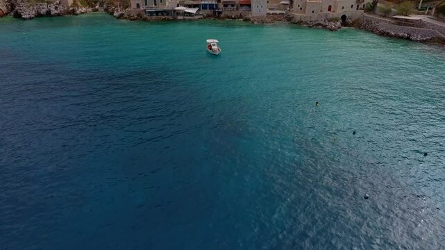 Aerial view of picturesque Limeni village with stone buildings and turquoise water, Peloponnese, Greece.