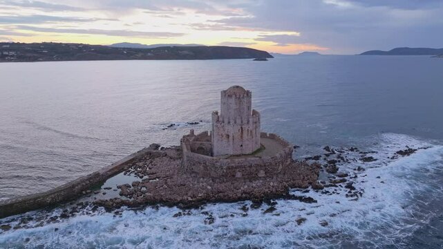 Aerial view of methoni castle at sunrise overlooking the mediterranean sea and rocky shore, methoni, greece.