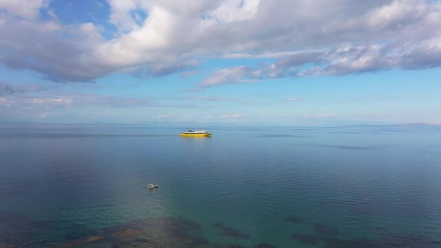 Aerial view of serene Ionian Sea with a ferry and picturesque coastline, Kyllini, Greece.