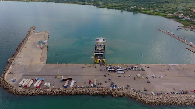 Kyllini, Greece - 01 December 2024: Aerial view of the bustling ferry terminal and dock with vehicles by the Ionian Sea, Kyllini, Greece.