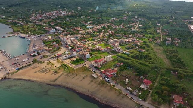 Aerial view of beautiful coastal village with sandy beach and scenic harbour along the Ionian Sea, Kyllini, Greece.