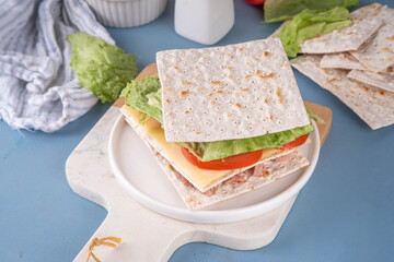 Tasty matzah sandwich with tuna, cheese, lettuce and vegetables. Viral club sandwich for Passover. Food ideas and recipe for Jewish Pesach holiday