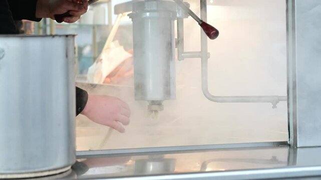 Churros, a type of fried dough pastry, are cooking in hot oil.