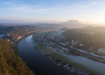 Winter sunset landscape of Saxon Switzerland in Germany and view from height of Bastei bridge. Sandstone mountains on Elbe River. Popular tourist destination.