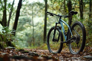A mountain bike parked against a scenic forest backdrop.
