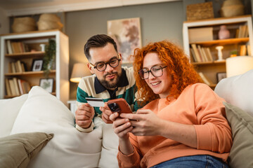 boyfriend and girlfriend use cellphone and credit card shopping online