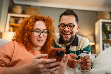 boyfriend and girlfriend use cellphone and credit card shopping online