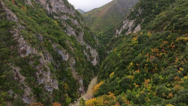 Aerial view of the beautiful Acheron Springs canyon with a winding river surrounded by lush greenery and rugged cliffs, Epirus, Greece.