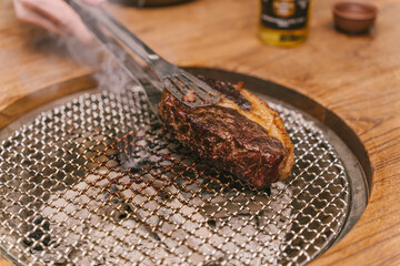 A piece of meat is on a metal pan