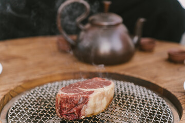 A piece of meat is on a metal pan