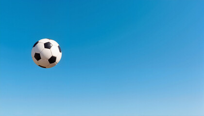 Soccer ball flying against clear blue sky, Start of the Football Season
