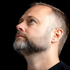 Fototapeta premium A man with a beard and a balding head looking up