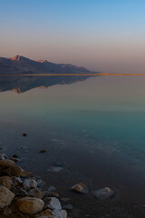 The beautiful Judean desert mountains reflected in the Dead Sea at Ein Bokek, Israel.
