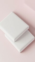 Two stacked blank books on a soft pink background, perfect for design mockups or artistic projects.