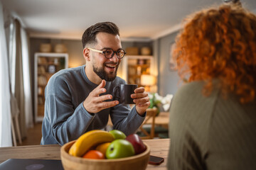 boyfriend enjoy while communicate with his girlfriend and drink coffee