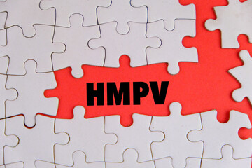 Picture of a healthcare worker wearing gloves holding a placard with HMPV written on it....