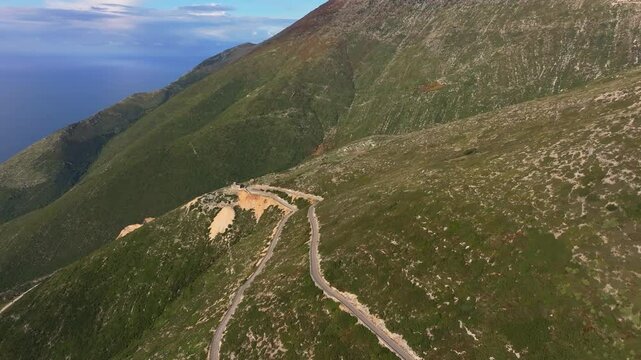 Aerial view of llogara pass in the ceraunian mountains with a winding road through the ducat valley, Palase, Albania.