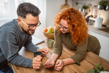 happy couple use mobile phone together and enjoy the slow morning