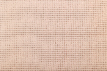 Fototapeta premium Texture of beige textile fabric. Texture of the back side of the carpet.