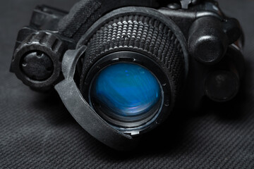 Front lens of military night vision device with image intensifier tube, macro photo.