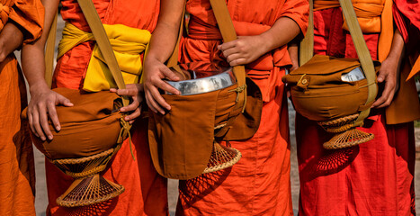 Buddhist monks in a line in Luang Prabang, Laos. Travel, Traditions and Culture	