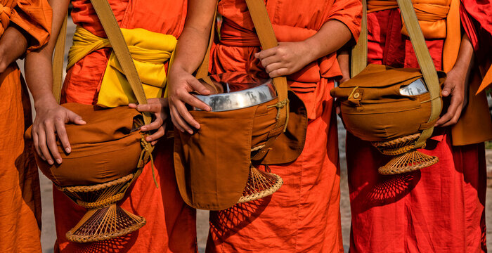 Buddhist monks in a line in Luang Prabang, Laos. Travel, Traditions and Culture	