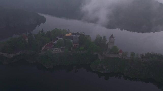 Aerial view of Zvikov Castle and the Moldau River at sunrise with mist and trees, Zvikovske Podhradi, Czech Republic.