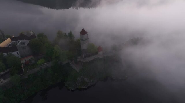 Aerial view of Zvikov Castle and the Moldau river shrouded in morning fog at sunrise, Zvikovske Podhradi, Czech Republic.
