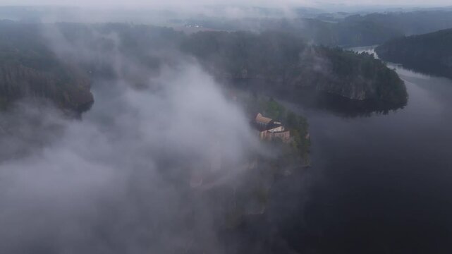Aerial view of Zvikov Castle and the Moldau river at sunrise with fog and mist, Zvikovske Podhradi, Czech Republic.