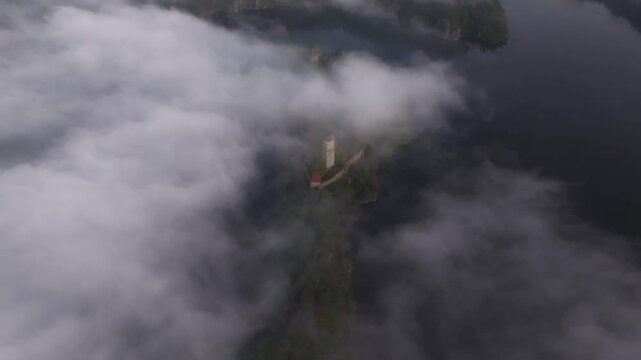 Aerial view of Zvikov Castle over the Moldau river at sunrise with clouds and mist, Zvikovske Podhradi, Czech Republic.