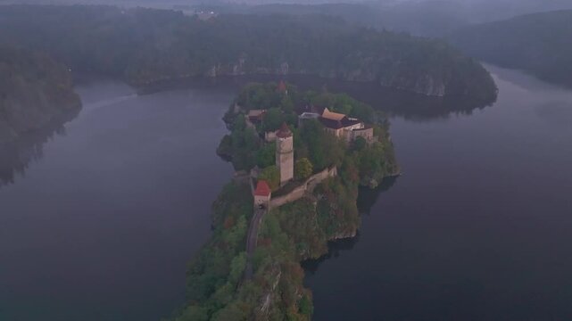 Aerial view of Zvikov Castle and the Moldau river at sunrise with mist and forest, Zvikovske Podhradi, Czech Republic.